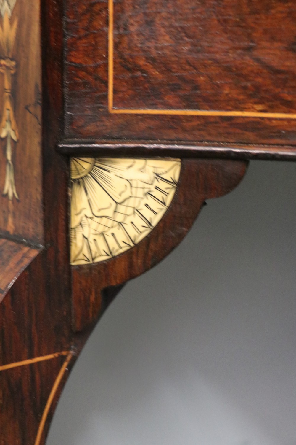 An early twentieth-century Sheraton Revival mahogany corner table featuring elaborate floral marquetry inlay, curved legs, and an undertier shelf. View X