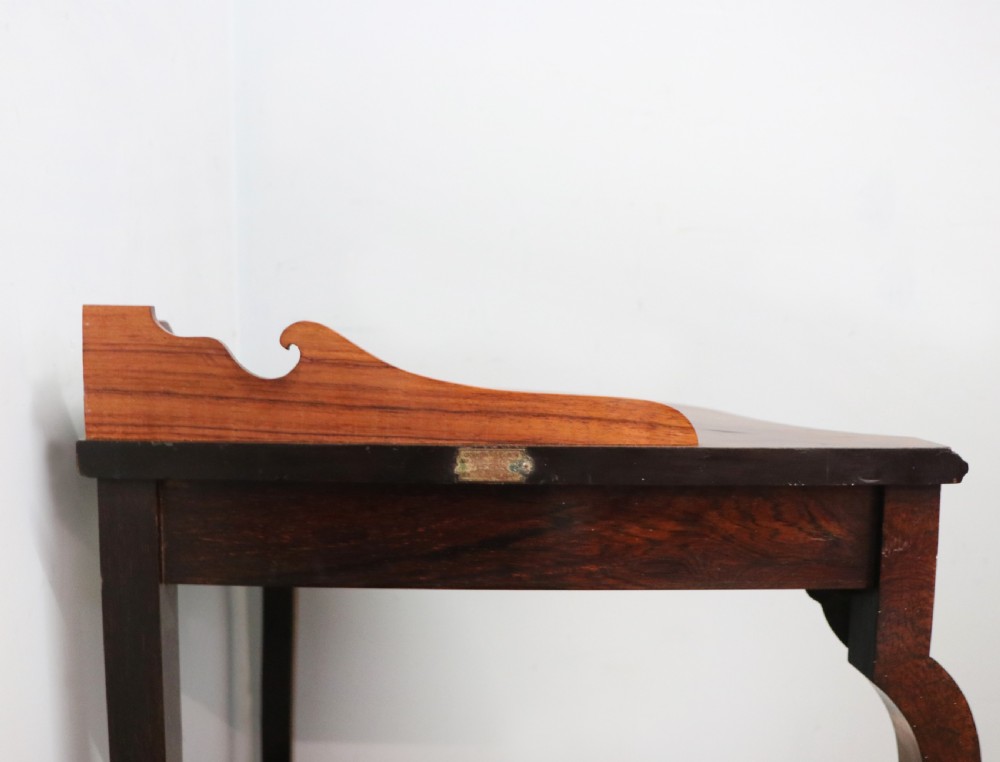 An early twentieth-century Sheraton Revival mahogany corner table featuring elaborate floral marquetry inlay, curved legs, and an undertier shelf. View XII