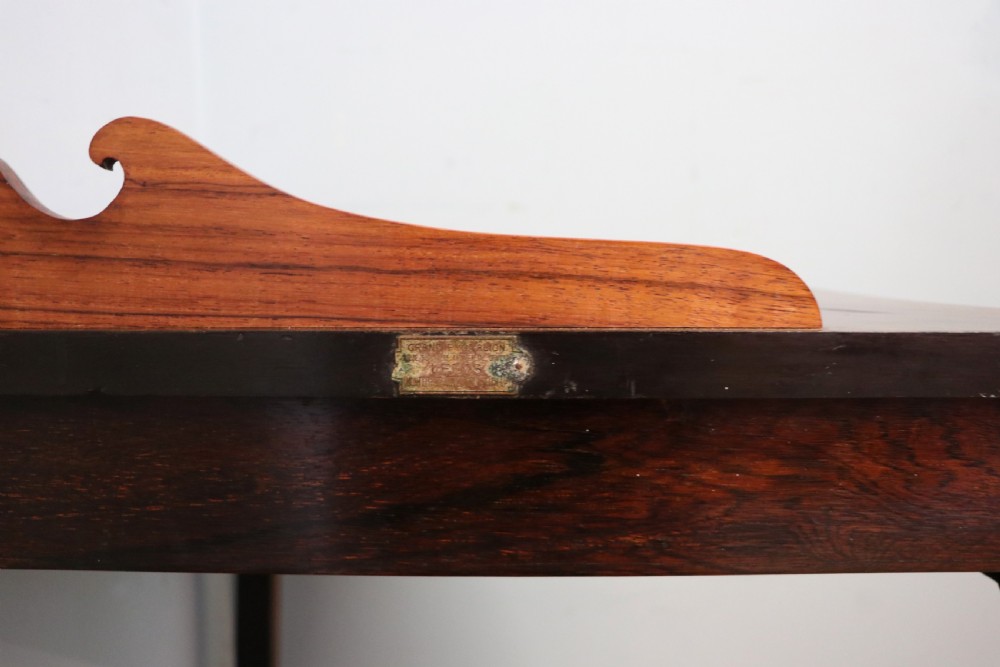 An early twentieth-century Sheraton Revival mahogany corner table featuring elaborate floral marquetry inlay, curved legs, and an undertier shelf. View XIV