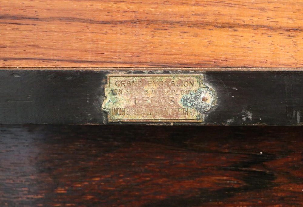 An early twentieth-century Sheraton Revival mahogany corner table featuring elaborate floral marquetry inlay, curved legs, and an undertier shelf. View XV