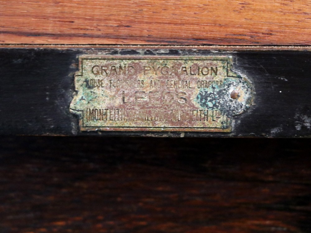 An early twentieth-century Sheraton Revival mahogany corner table featuring elaborate floral marquetry inlay, curved legs, and an undertier shelf. View XVI