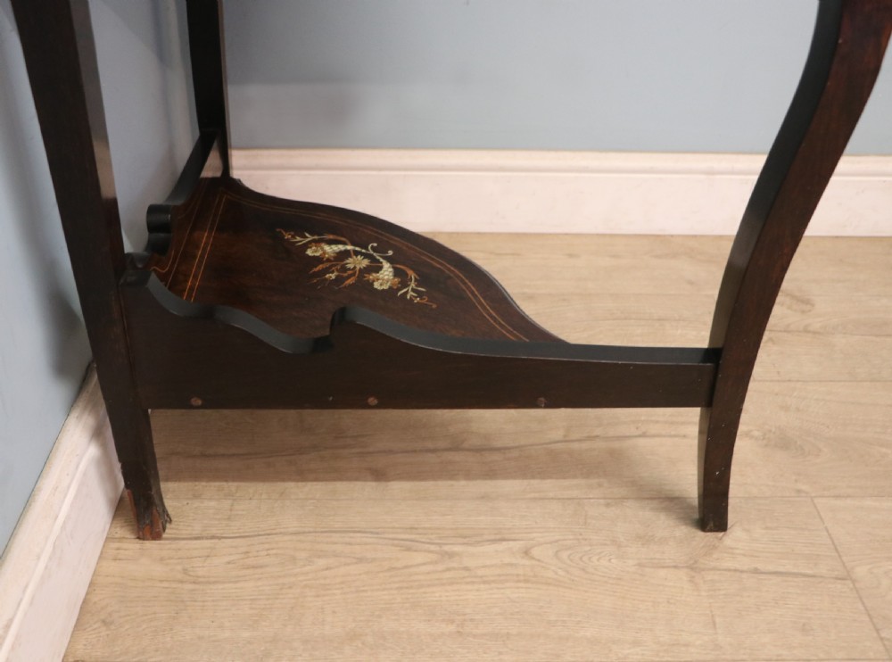 An early twentieth-century Sheraton Revival mahogany corner table featuring elaborate floral marquetry inlay, curved legs, and an undertier shelf. View XXI