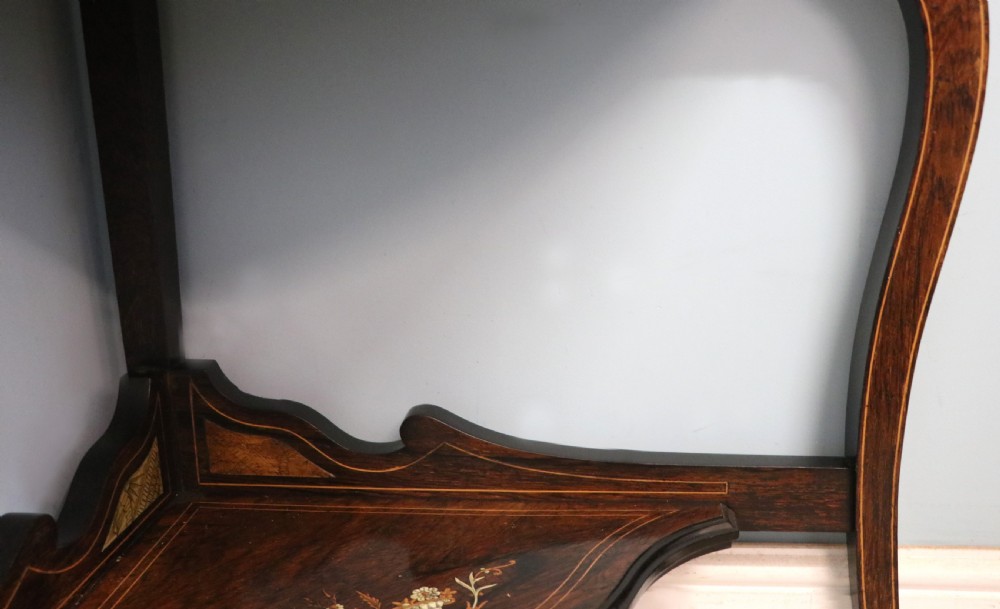 An early twentieth-century Sheraton Revival mahogany corner table featuring elaborate floral marquetry inlay, curved legs, and an undertier shelf. View XXII