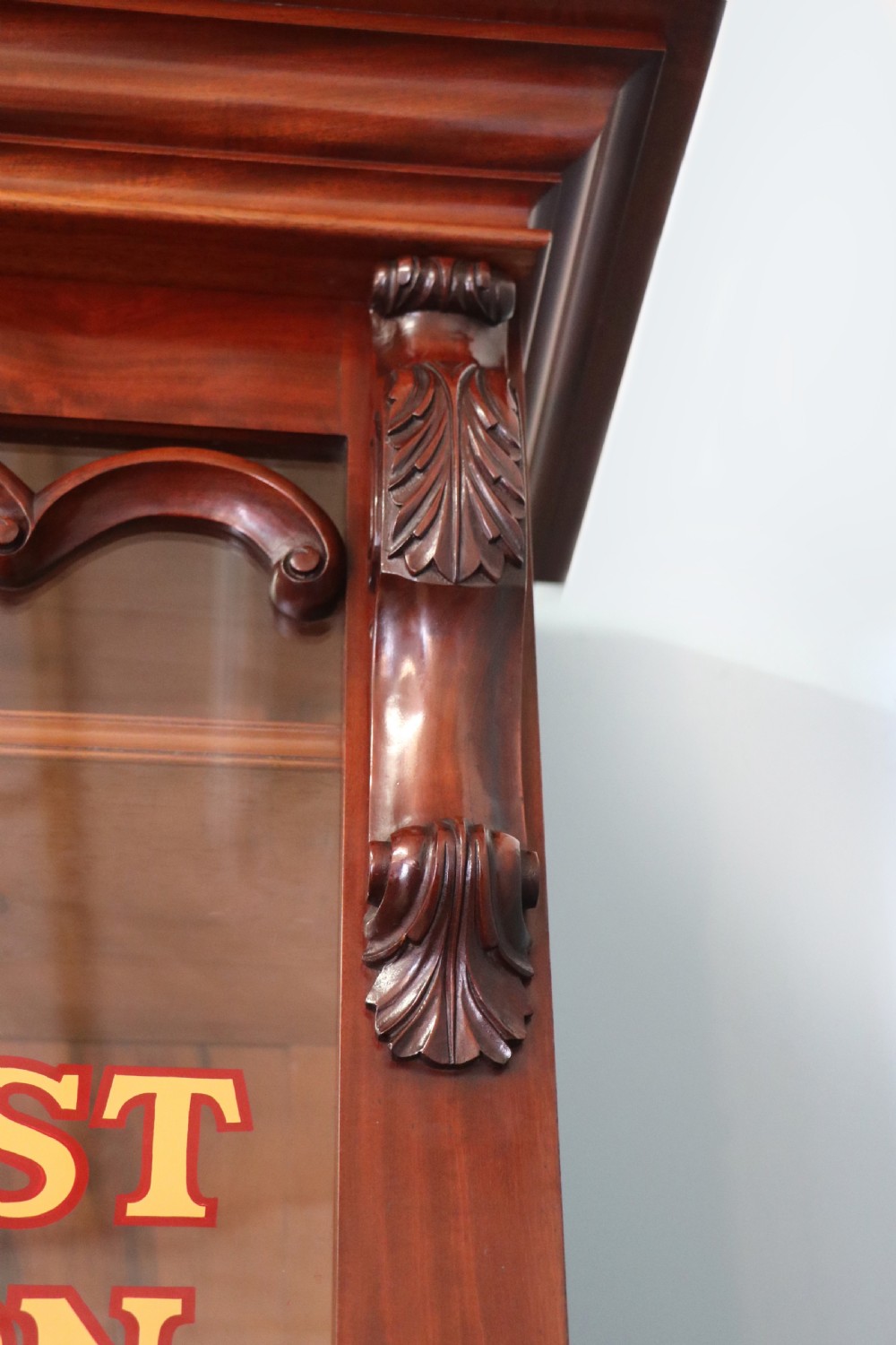 A Victorian mahogany two-height glazed bookcase featuring gilt advertising lettering on the glass doors and lower panelled doors. View XII