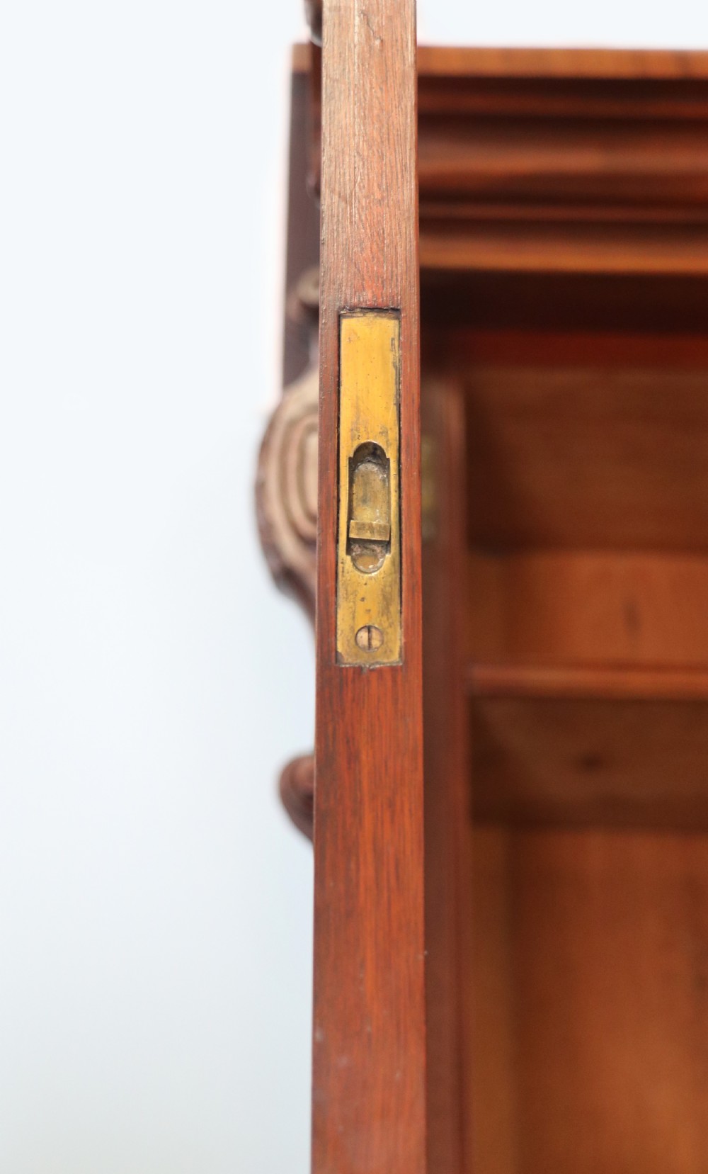 A Victorian mahogany two-height glazed bookcase featuring gilt advertising lettering on the glass doors and lower panelled doors. View XV