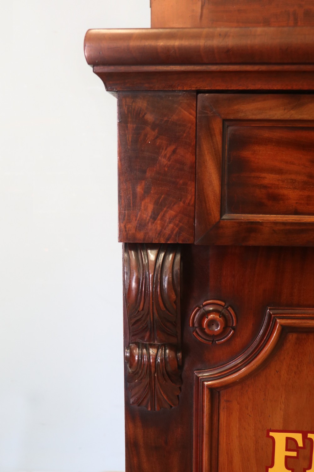 A Victorian mahogany two-height glazed bookcase featuring gilt advertising lettering on the glass doors and lower panelled doors. View XXIV