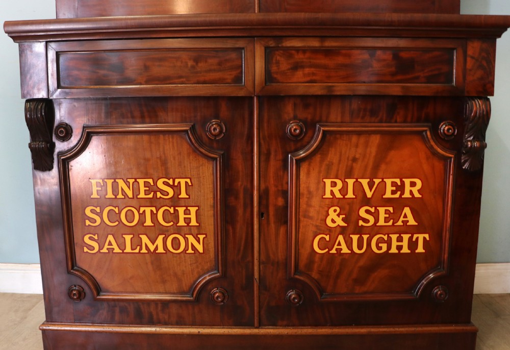 A Victorian mahogany two-height glazed bookcase featuring gilt advertising lettering on the glass doors and lower panelled doors. View XXVIII