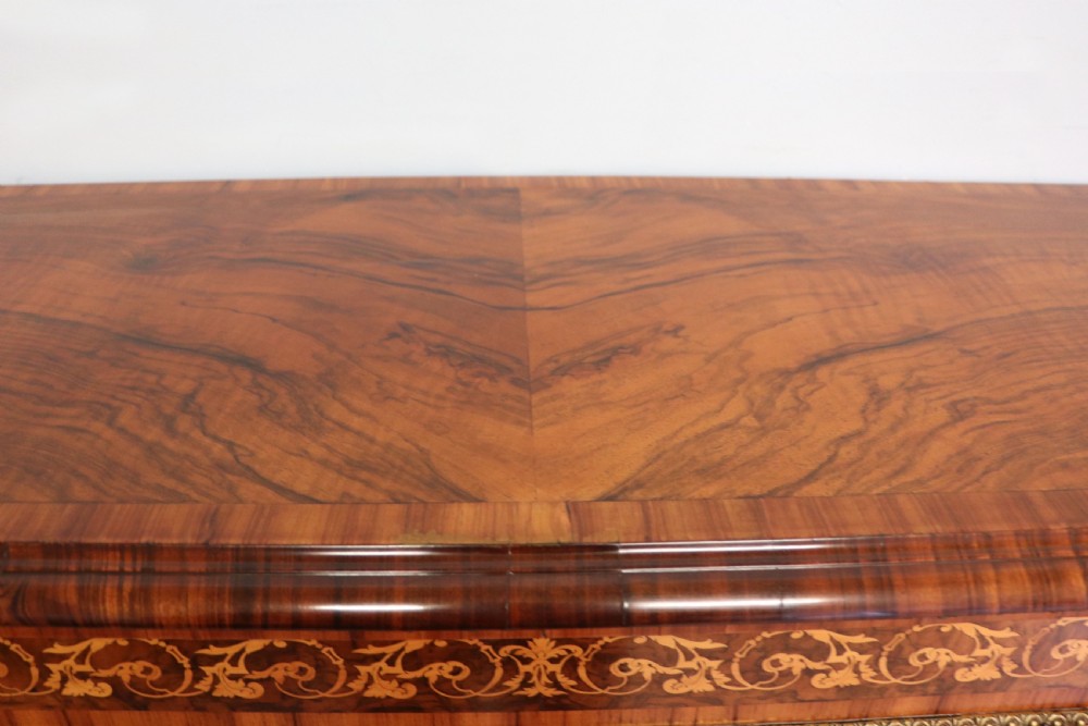 A Victorian walnut credenza featuring floral marquetry inlay, a central glazed door, two curved glass side doors, and gilt metal mounts. View XV