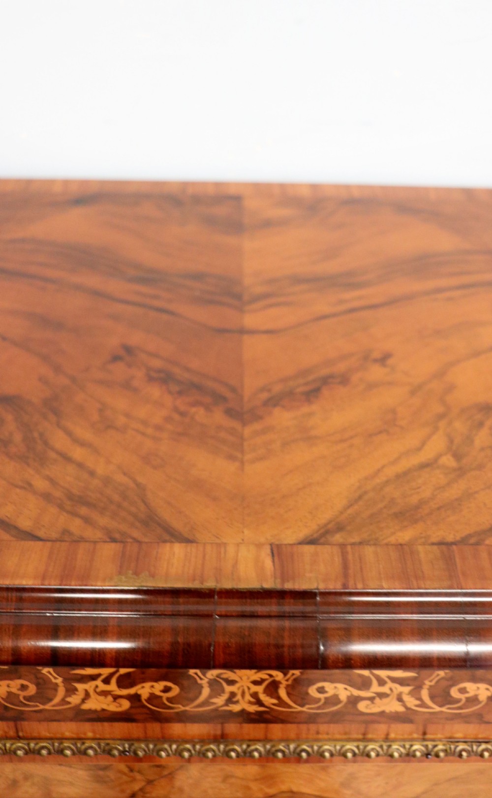 A Victorian walnut credenza featuring floral marquetry inlay, a central glazed door, two curved glass side doors, and gilt metal mounts. View XVI