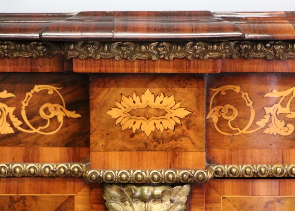 A Victorian walnut credenza featuring floral marquetry inlay, a central glazed door, two curved glass side doors, and gilt metal mounts. View XXVII