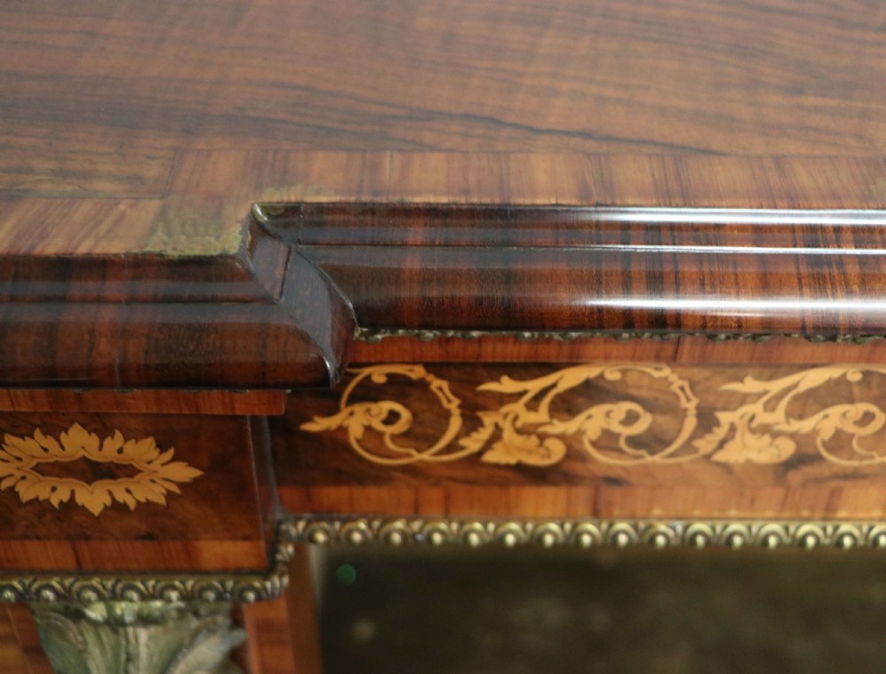 A Victorian walnut credenza featuring floral marquetry inlay, a central glazed door, two curved glass side doors, and gilt metal mounts. View XXVIII