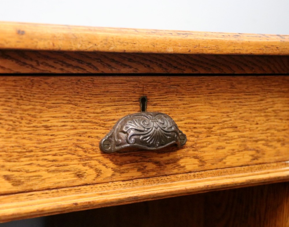 Victorian quality! A lovely late 19th century light oak twin pedestal desk.  View XVI
