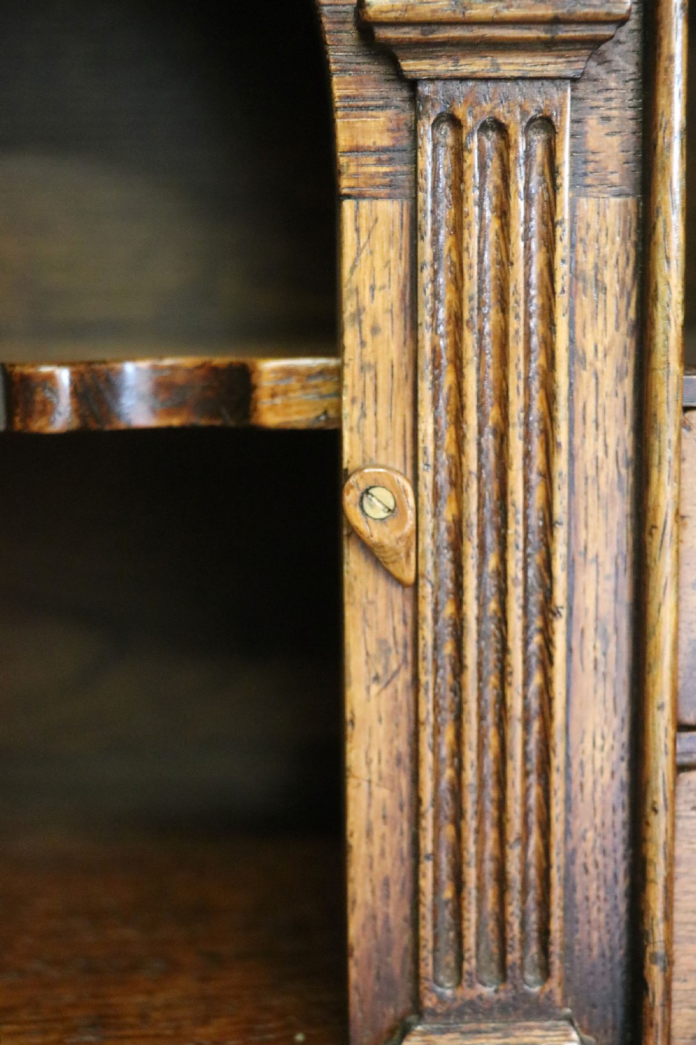 A Georgian style warm brown oak bureau cabinet featuring two upper arched doors opening to a fitted interior of pigeonholes and small drawers above three long drawers with brass handles. View XXVIII