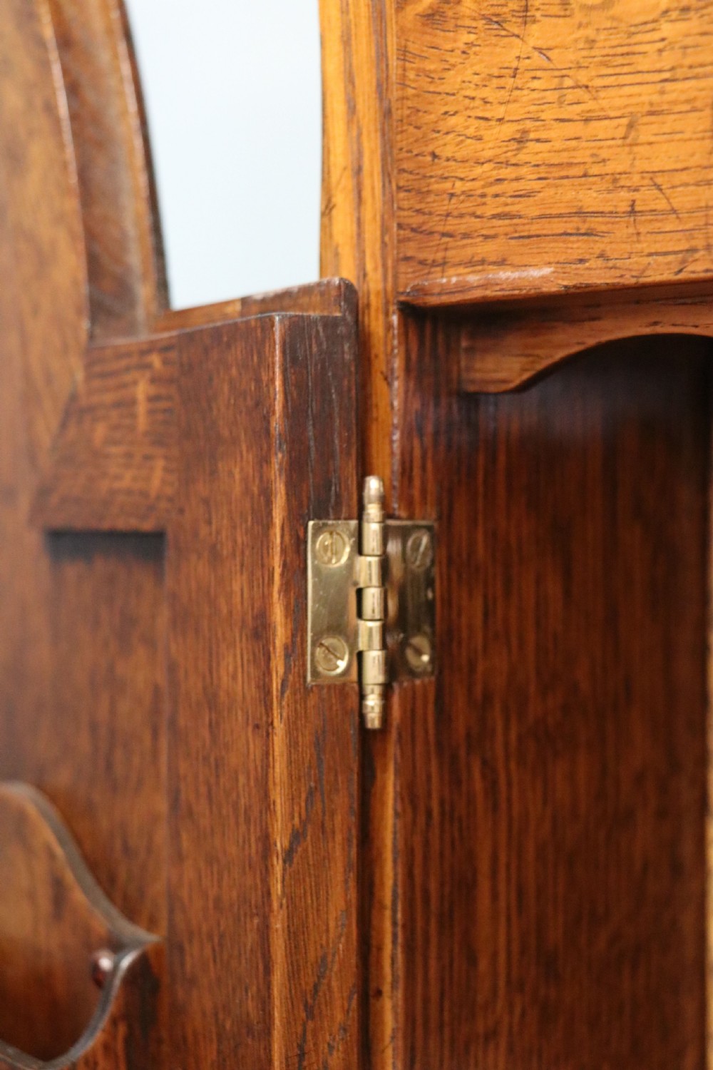 A Georgian style warm brown oak bureau cabinet featuring two upper arched doors opening to a fitted interior of pigeonholes and small drawers above three long drawers with brass handles. View XXX