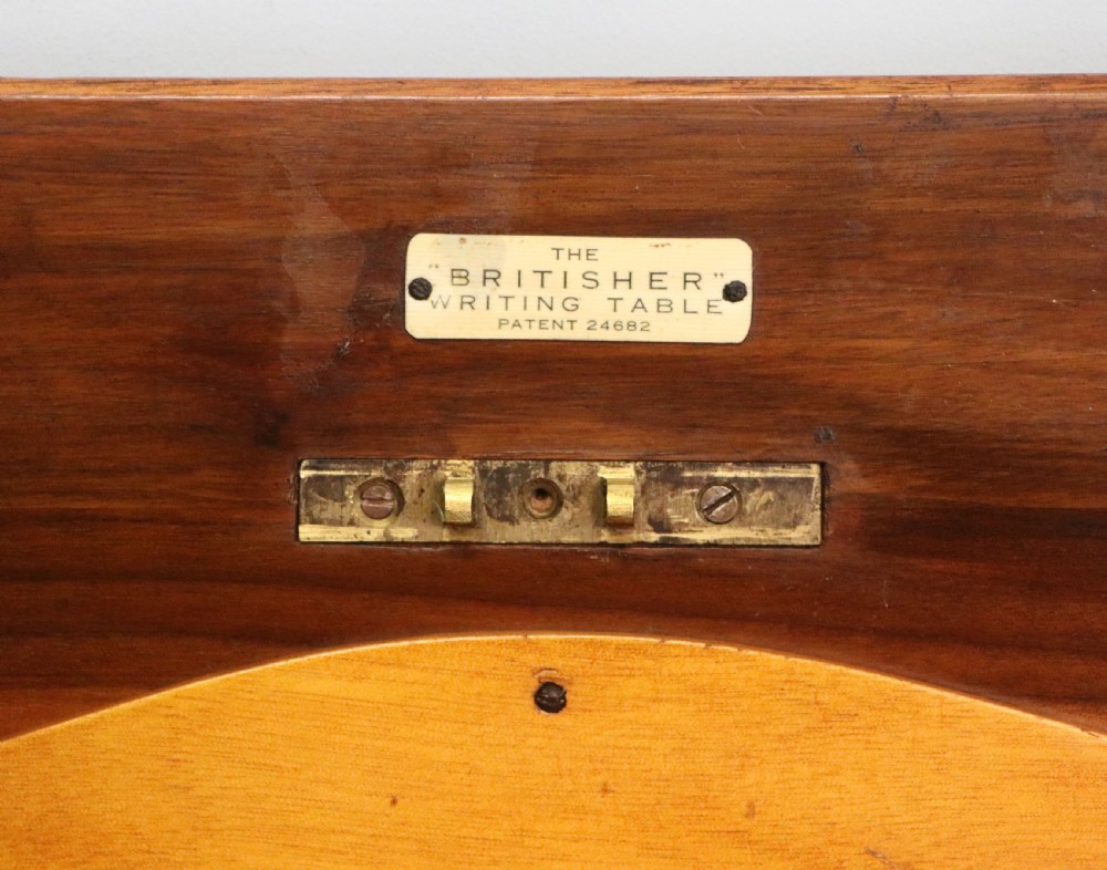 A brown walnut metamorphic writing desk featuring turned legs, side flaps, and an open top section exposing internal stationery compartments. View XVIII