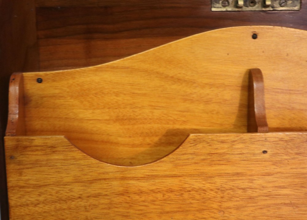 A brown walnut metamorphic writing desk featuring turned legs, side flaps, and an open top section exposing internal stationery compartments. View XXII