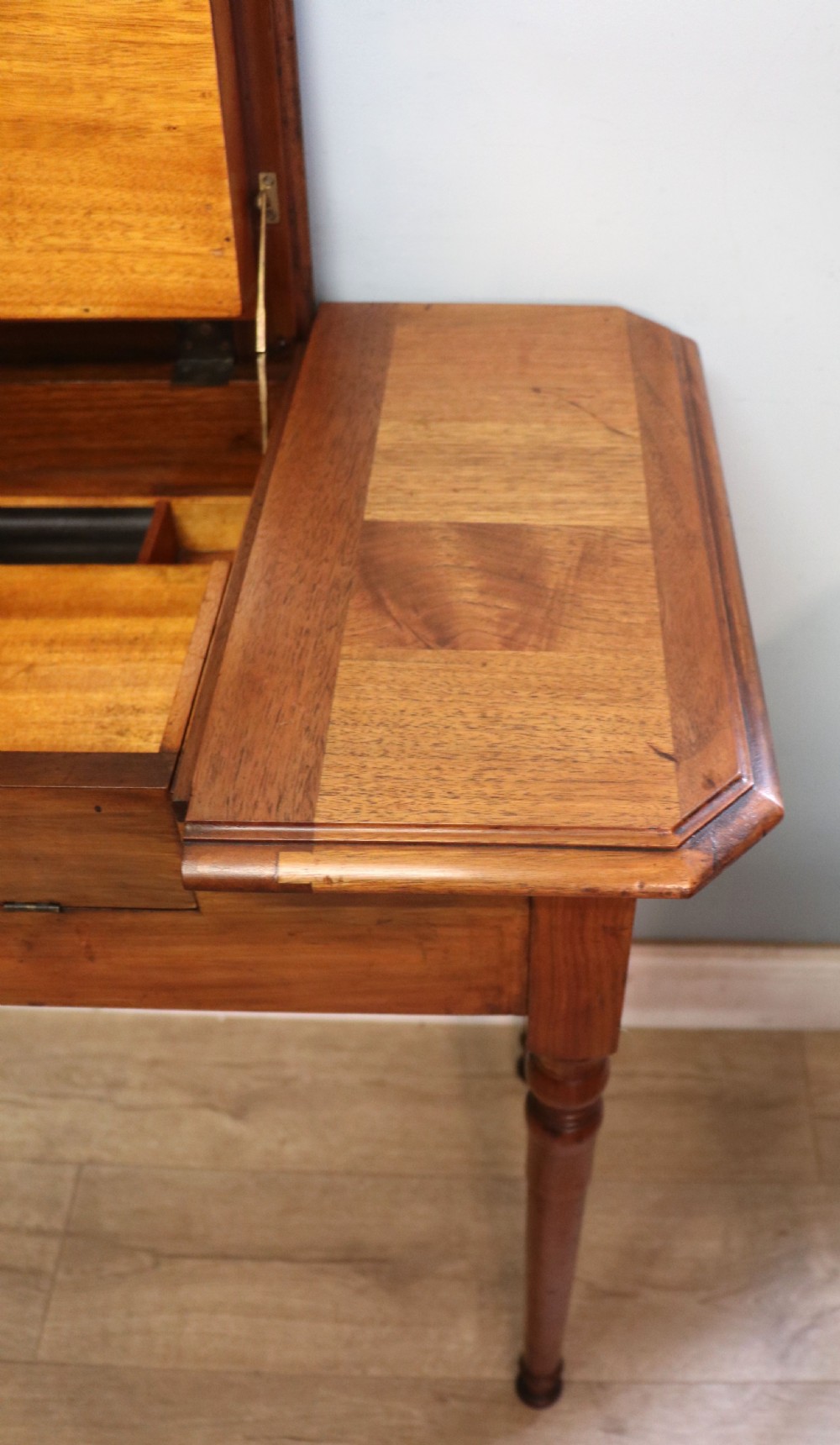 A brown walnut metamorphic writing desk featuring turned legs, side flaps, and an open top section exposing internal stationery compartments. View XXVII