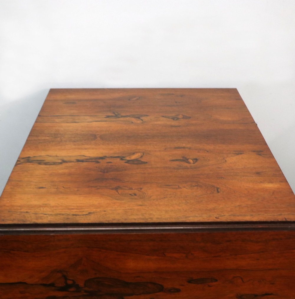A late Georgian drop-leaf sofa table crafted from dark figured rosewood with a turned pedestal stem, two frieze drawers, and splayed quadruped legs with brass castors. View XI