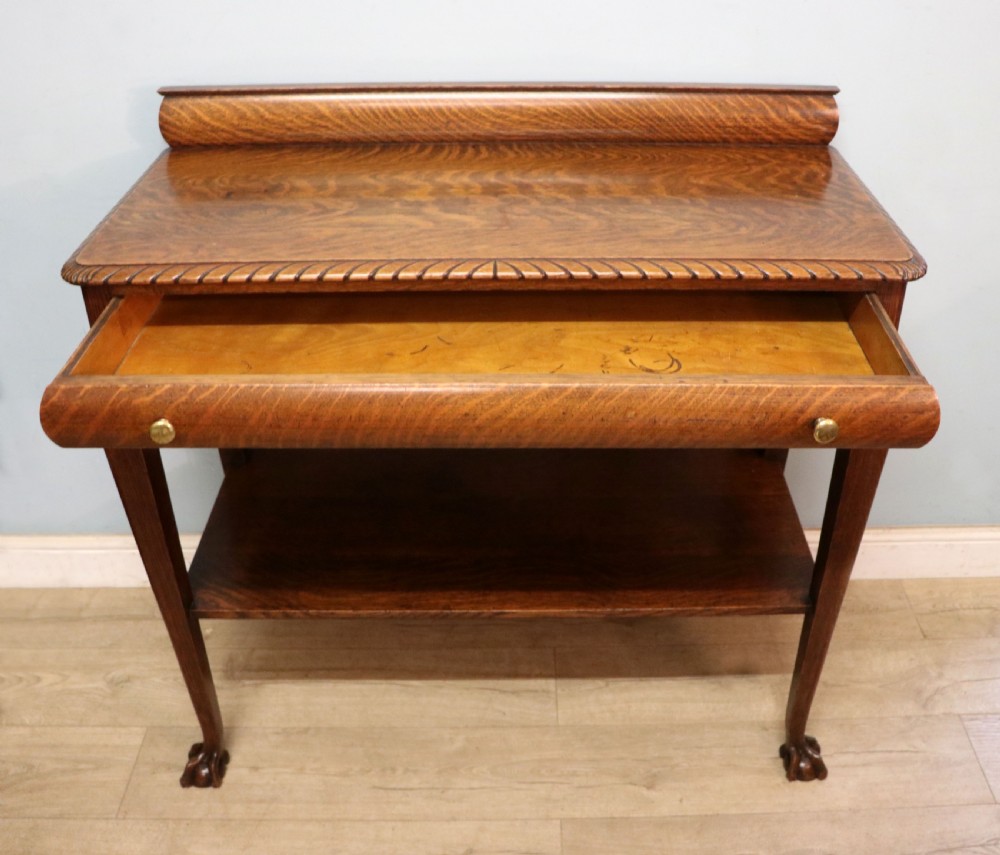 A Georgian revival oak side table featuring a single drawer with brass knobs, a lower tier shelf, and cabriole legs terminating in carved claw and ball feet. View III