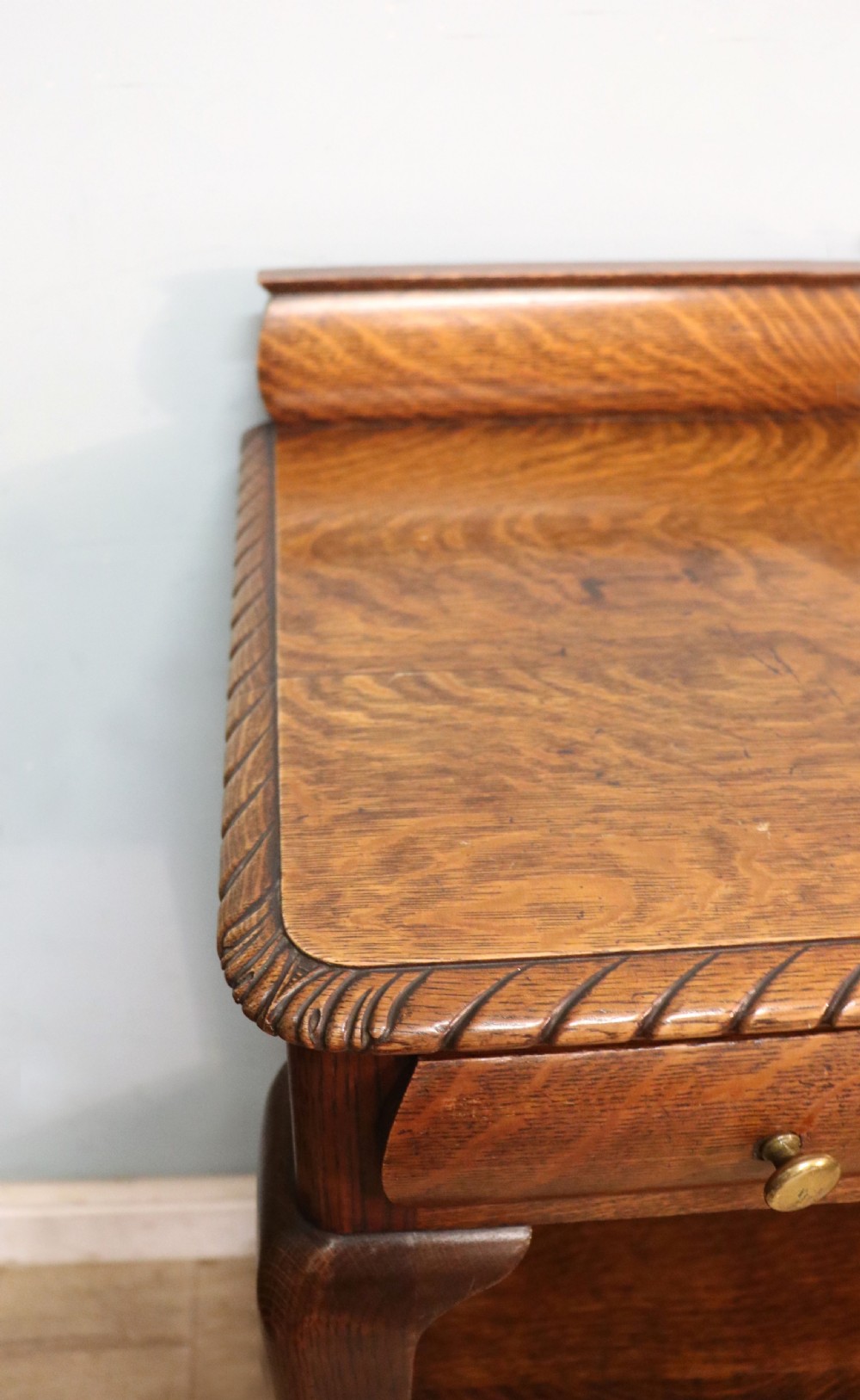 A Georgian revival oak side table featuring a single drawer with brass knobs, a lower tier shelf, and cabriole legs terminating in carved claw and ball feet. View IX