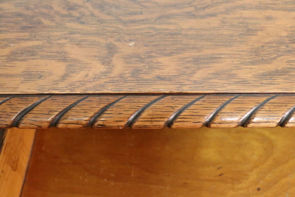 A Georgian revival oak side table featuring a single drawer with brass knobs, a lower tier shelf, and cabriole legs terminating in carved claw and ball feet. View X