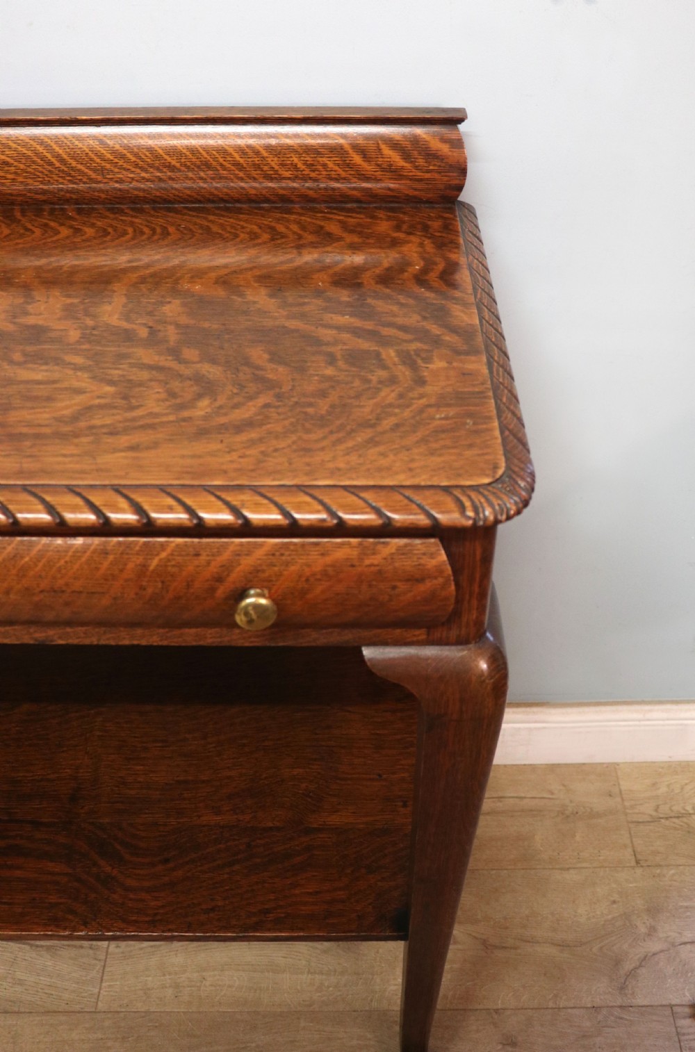 A Georgian revival oak side table featuring a single drawer with brass knobs, a lower tier shelf, and cabriole legs terminating in carved claw and ball feet. View XI