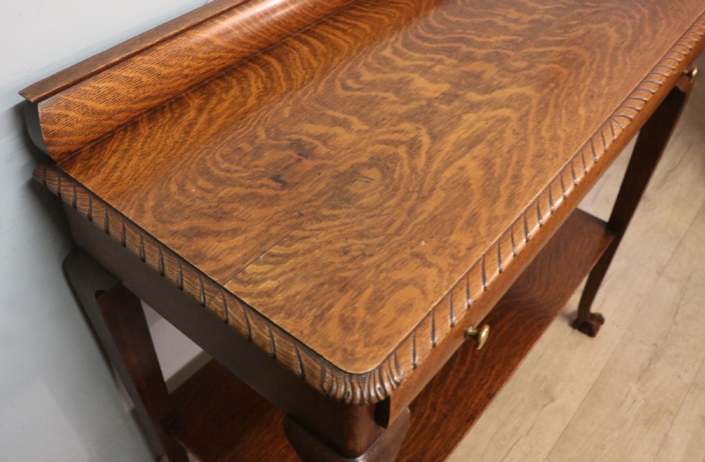 A Georgian revival oak side table featuring a single drawer with brass knobs, a lower tier shelf, and cabriole legs terminating in carved claw and ball feet. View XIII
