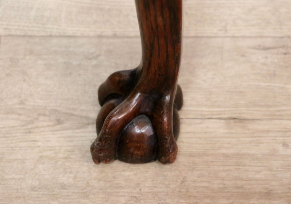 A Georgian revival oak side table featuring a single drawer with brass knobs, a lower tier shelf, and cabriole legs terminating in carved claw and ball feet. View XX