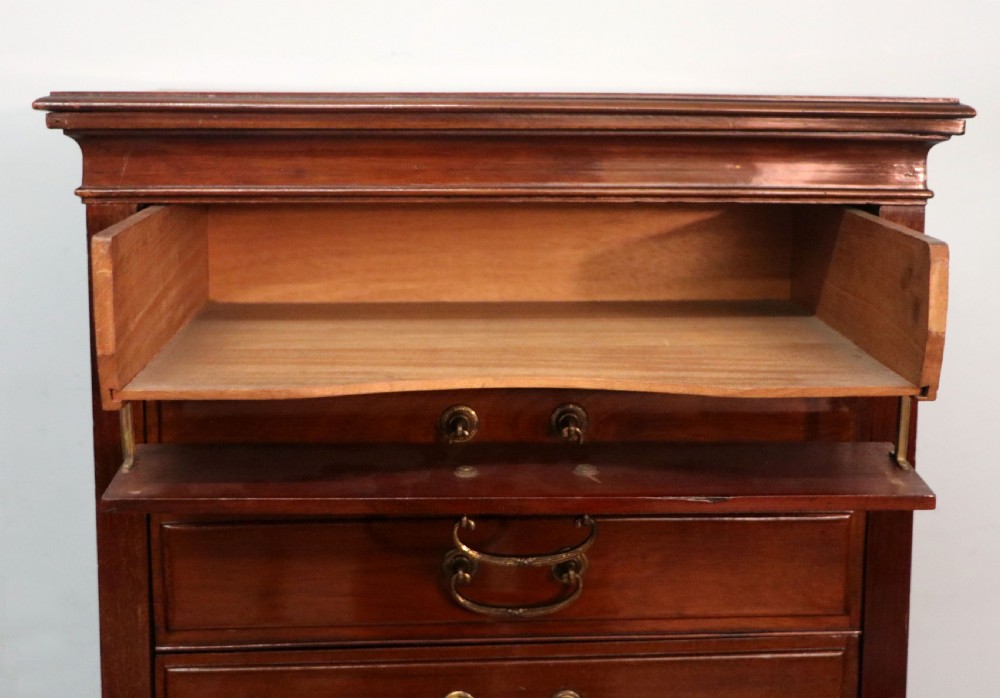 A lovely unusual early 20th century mahogany music cabinet or chest with ten drawers. View XVIII