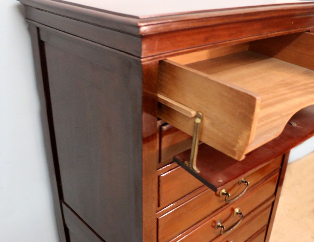 A lovely unusual early 20th century mahogany music cabinet or chest with ten drawers. View XIX