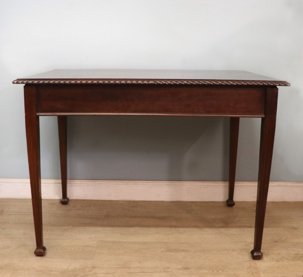 An Edwardian rectangular mahogany side table featuring carved rope-twist edging and square tapered legs. View II
