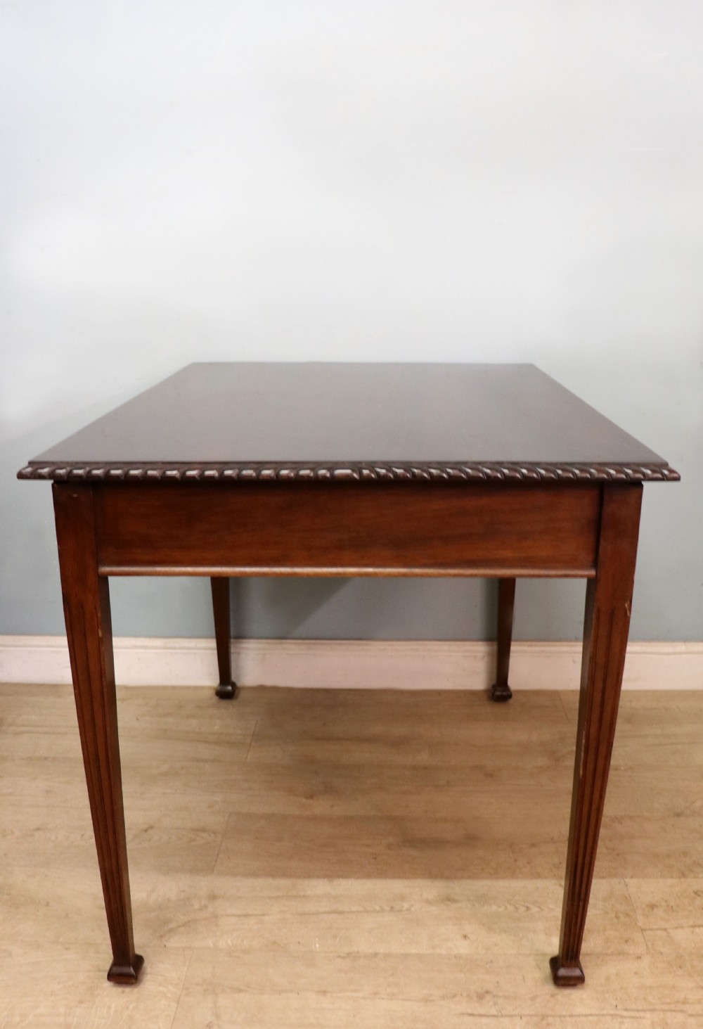 An Edwardian rectangular mahogany side table featuring carved rope-twist edging and square tapered legs. View IV