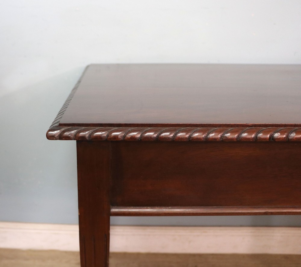 An Edwardian rectangular mahogany side table featuring carved rope-twist edging and square tapered legs. View VI