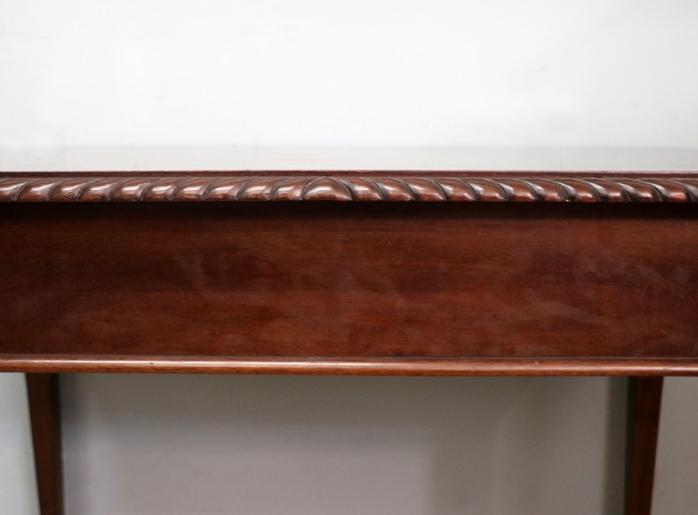 An Edwardian rectangular mahogany side table featuring carved rope-twist edging and square tapered legs. View VIII