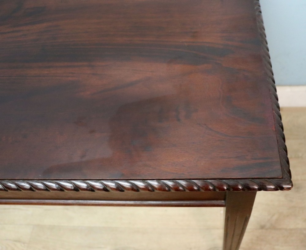 An Edwardian rectangular mahogany side table featuring carved rope-twist edging and square tapered legs. View X