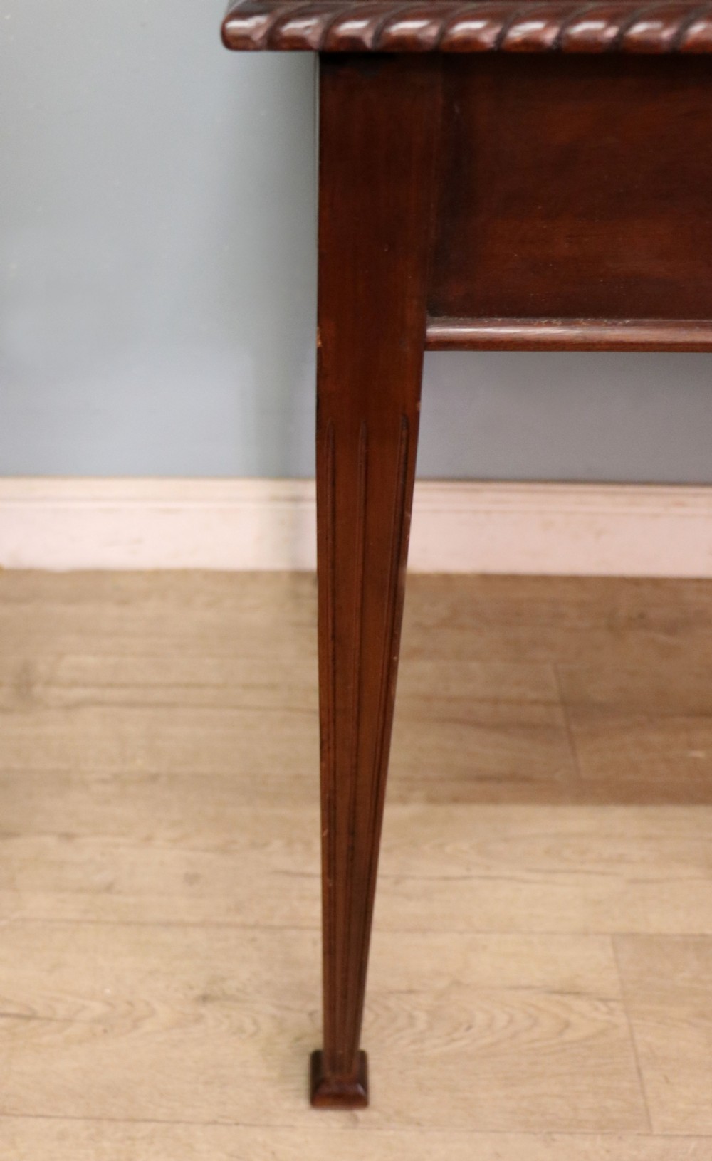 An Edwardian rectangular mahogany side table featuring carved rope-twist edging and square tapered legs. View XVI