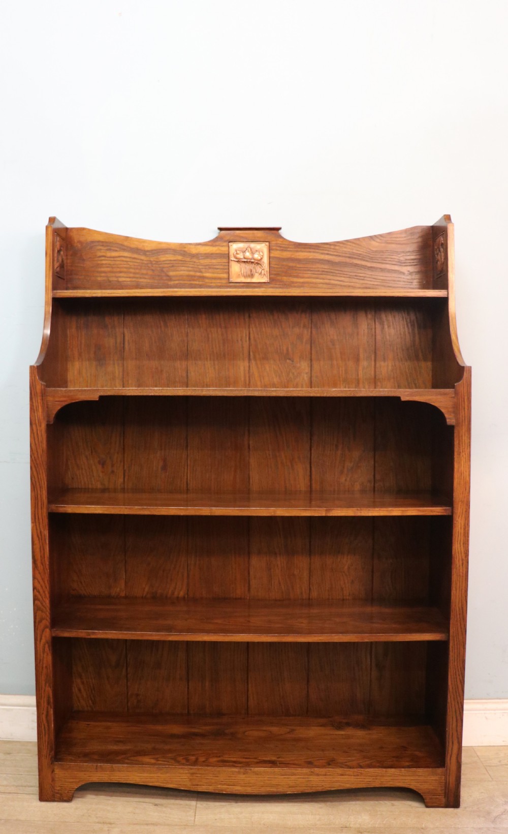 A lovely early 20th century oak open front bookcase, bear the signature of Albert Gilles a renowned French coppersmith. 