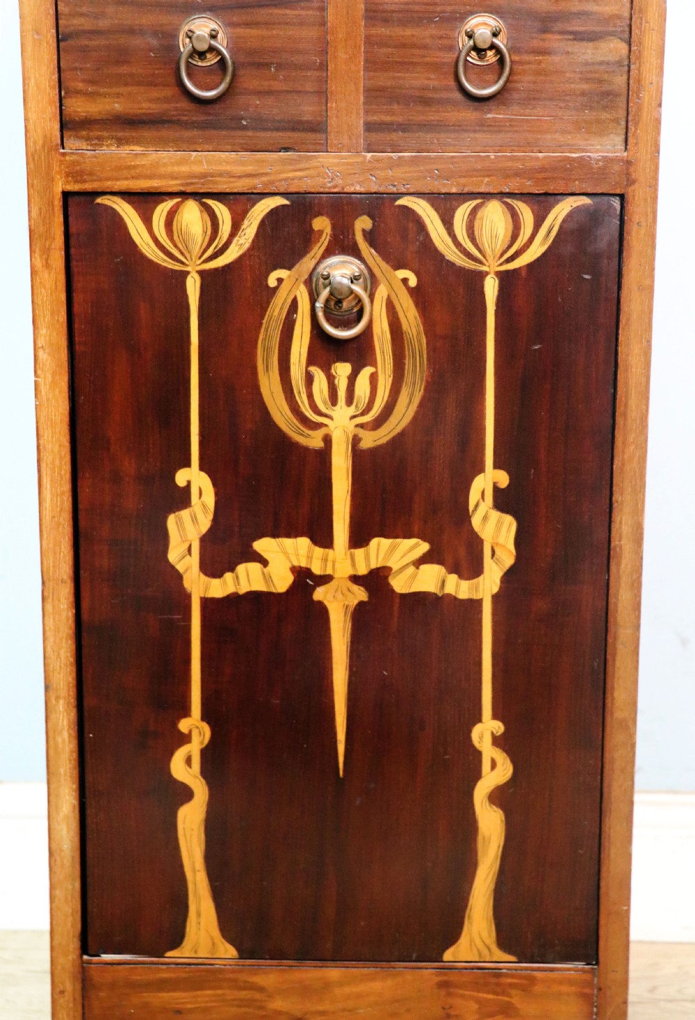 A tall dark wood Art Nouveau coal box featuring botanical marquetry inlay and brass ring handles, supported on castors. View XIX
