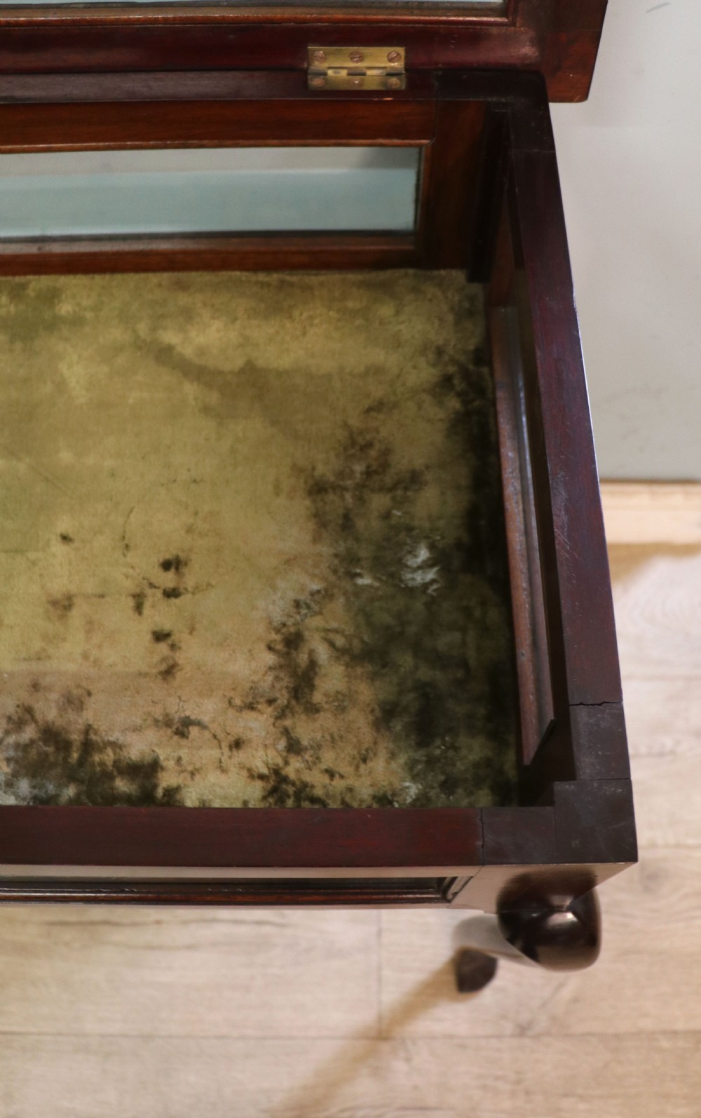 A dark mahogany glazed bijouterie table featuring cabriole legs, a glass top with blue Breitling watch branding, and a lined interior display compartment. View XIX