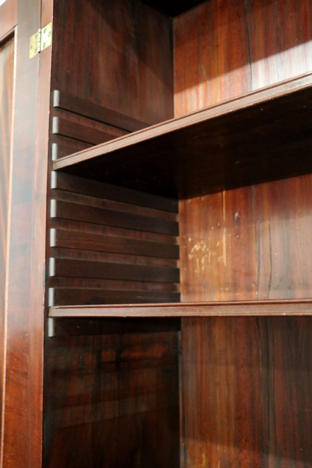 A George III mahogany bureau bookcase featuring a panelled upper cabinet above a fall-front writing surface and graduated drawers with brass hardware. View XV