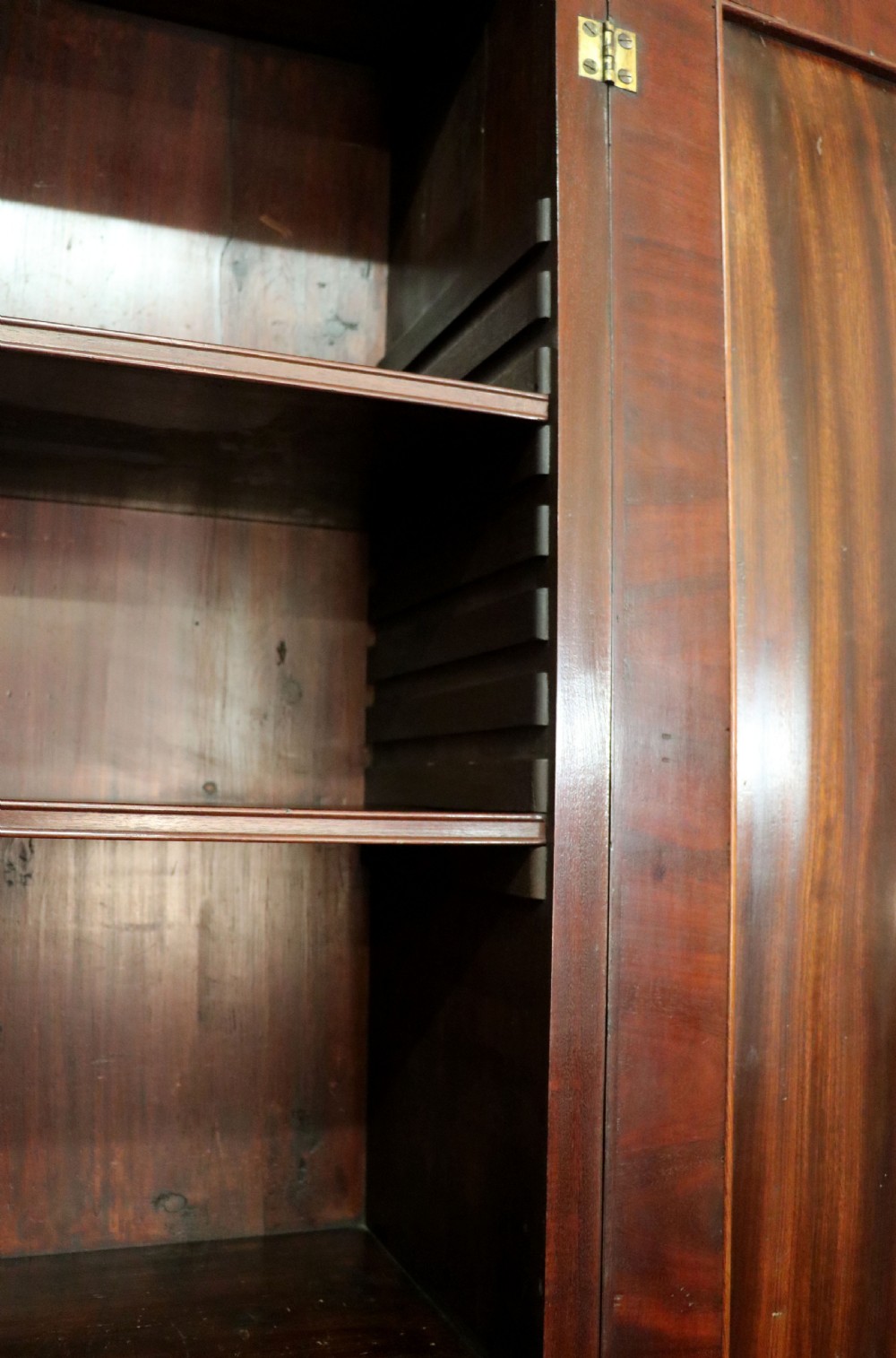 A George III mahogany bureau bookcase featuring a panelled upper cabinet above a fall-front writing surface and graduated drawers with brass hardware. View XVI