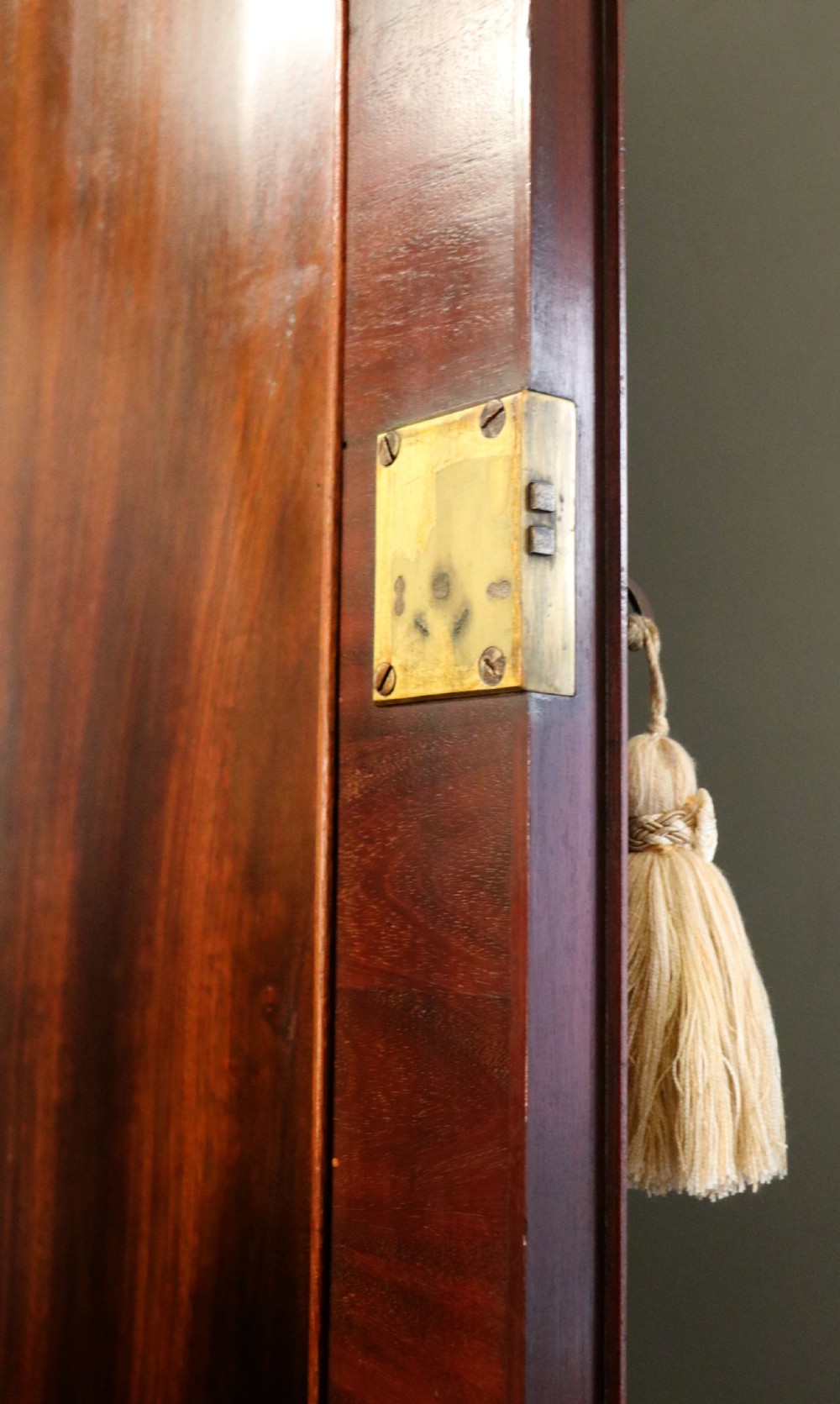 A George III mahogany bureau bookcase featuring a panelled upper cabinet above a fall-front writing surface and graduated drawers with brass hardware. View XXI