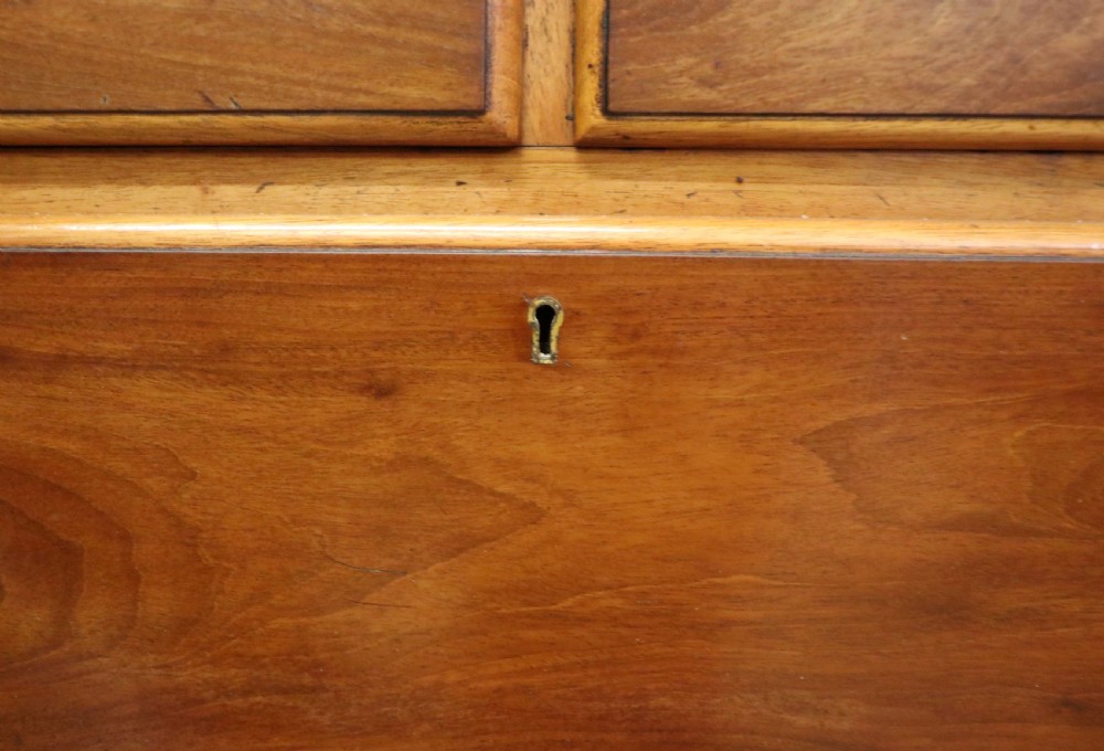 A mid-nineteenth century mahogany chest of drawers featuring two short drawers over two long drawers, turned wooden handles, and a shaped galleried backboard. View XV