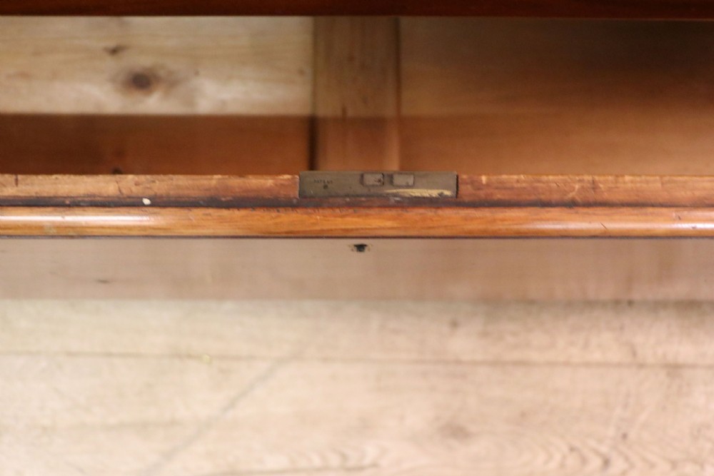 A mid-nineteenth century mahogany chest of drawers featuring two short drawers over two long drawers, turned wooden handles, and a shaped galleried backboard. View XXII