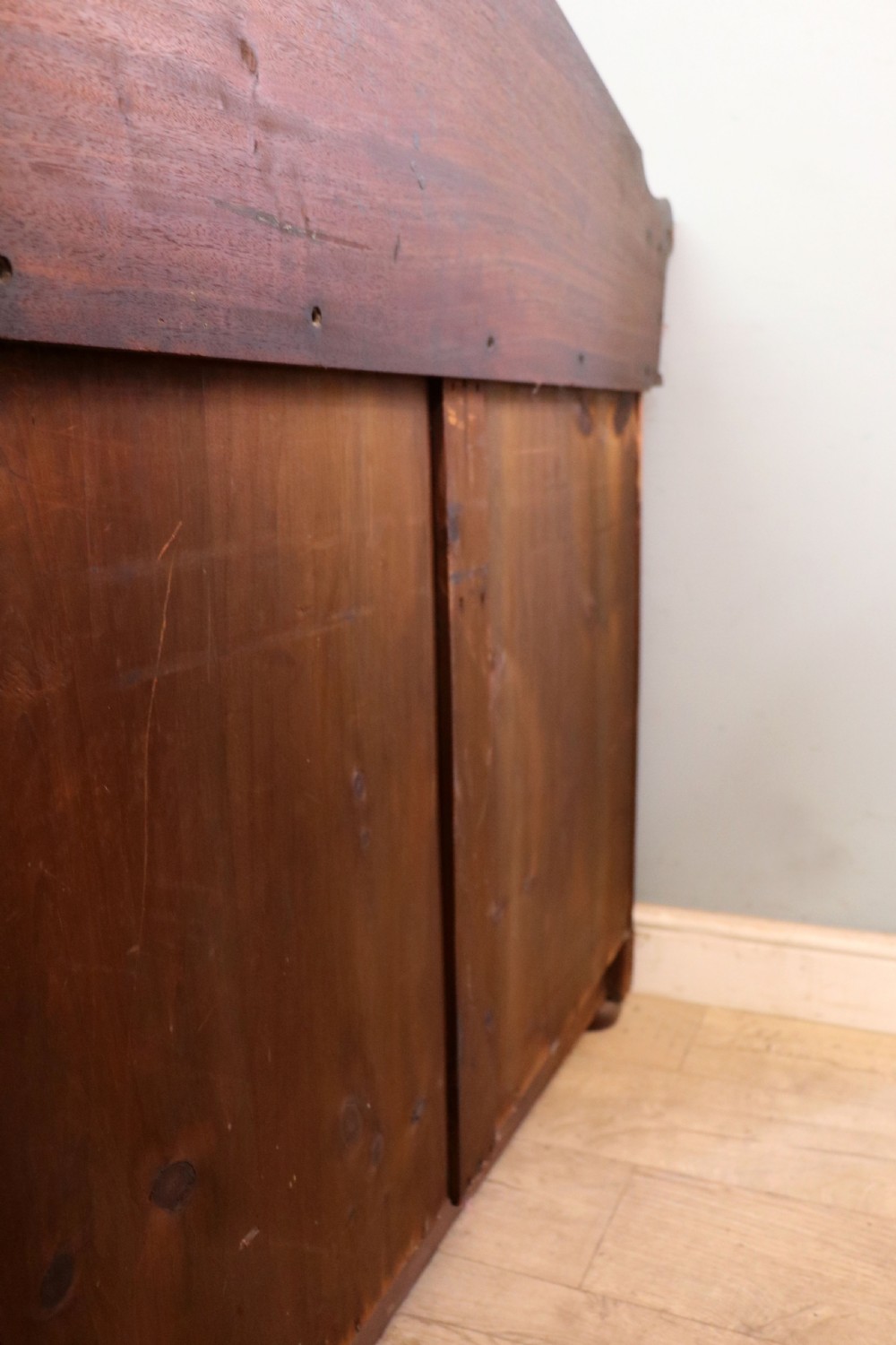 A mid-nineteenth century mahogany chest of drawers featuring two short drawers over two long drawers, turned wooden handles, and a shaped galleried backboard. View XXVI