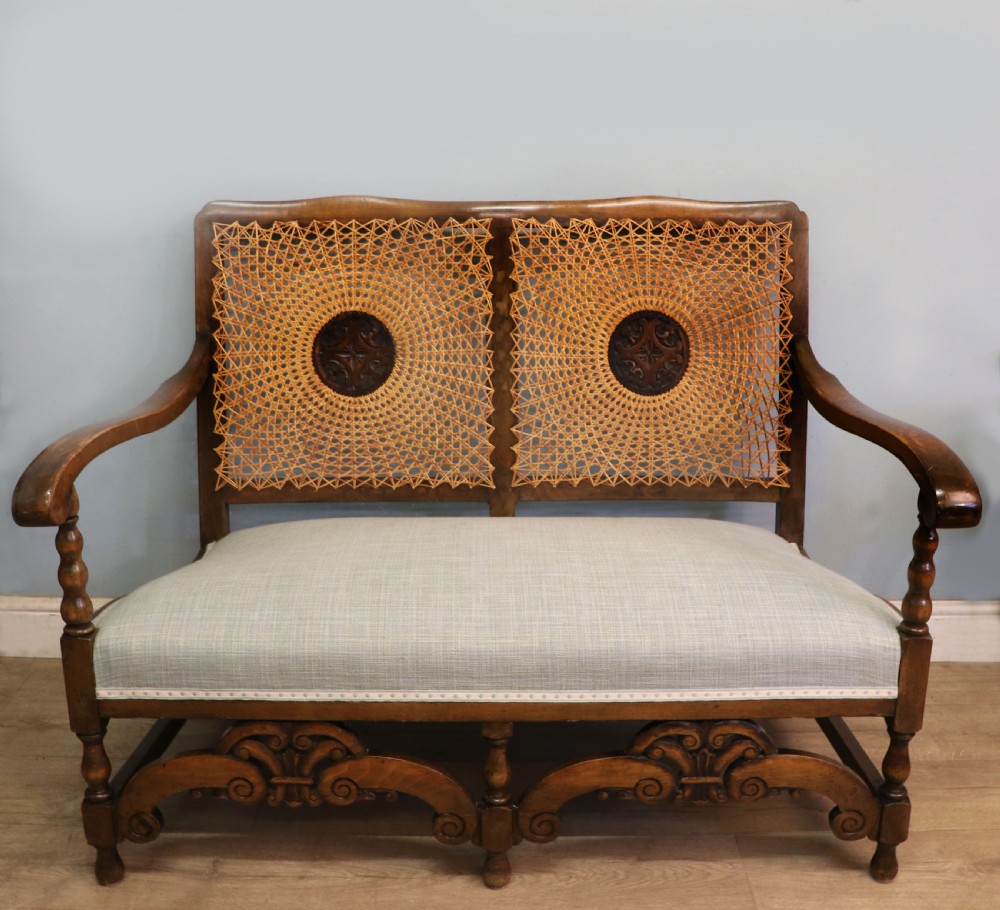  A charming early 20th century two-seater solid oak framed sofa modelled in the late 17th century style.  View II