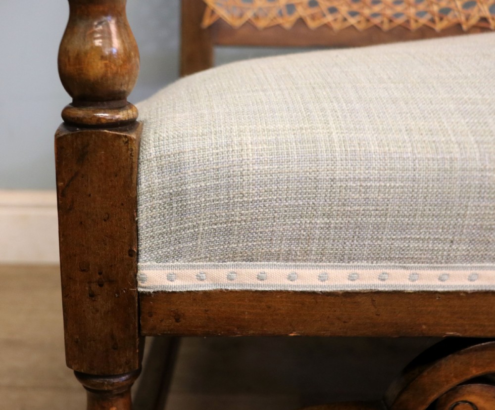  A charming early 20th century two-seater solid oak framed sofa modelled in the late 17th century style.  View XIV