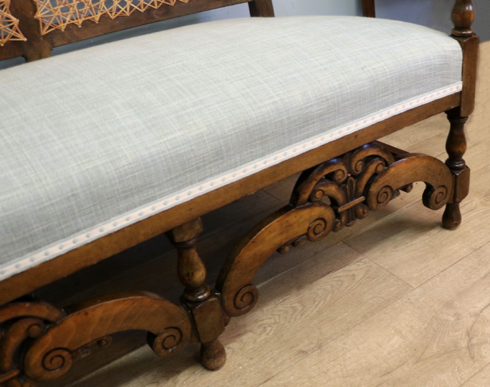  A charming early 20th century two-seater solid oak framed sofa modelled in the late 17th century style.  View XIX