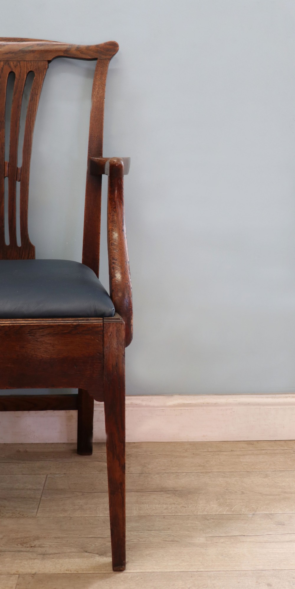 A pair of early 19th century dark timber carver chairs featuring open pierced splats, swept armrests, and dark upholstered seats. View XI