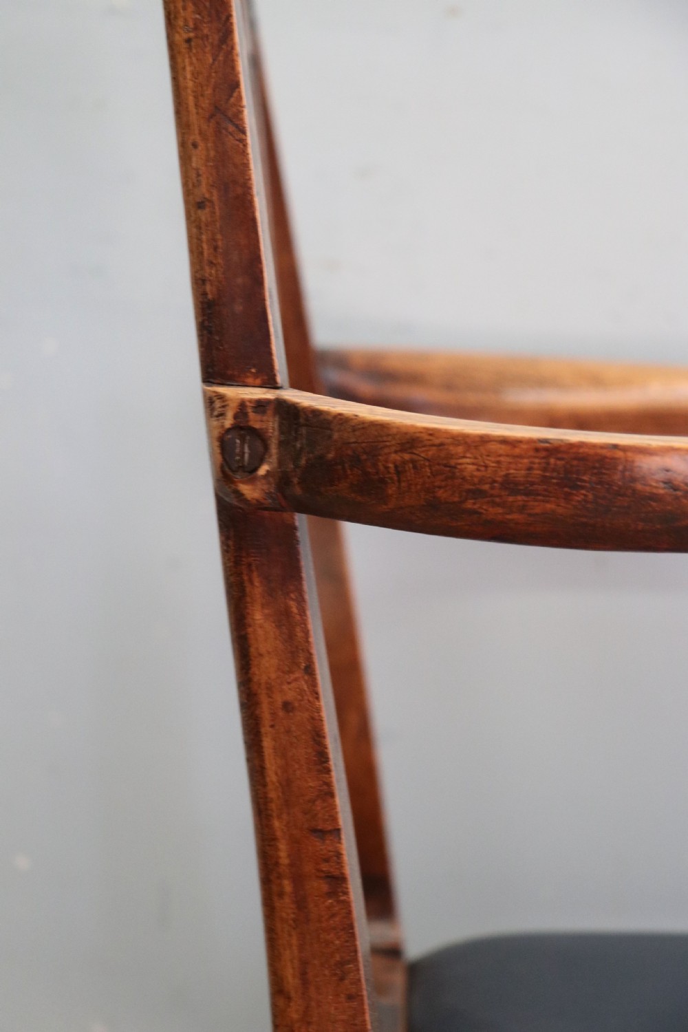 A pair of early 19th century dark timber carver chairs featuring open pierced splats, swept armrests, and dark upholstered seats. View XIV